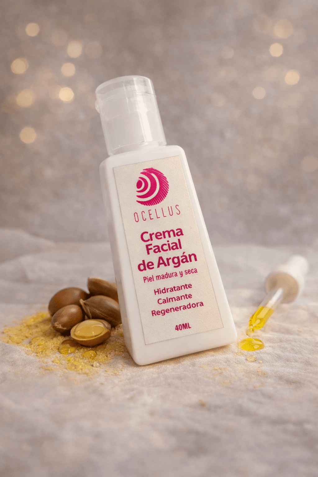 Botella de crema facial de argán Ocellus con nueces de argán y gotero de aceite.
